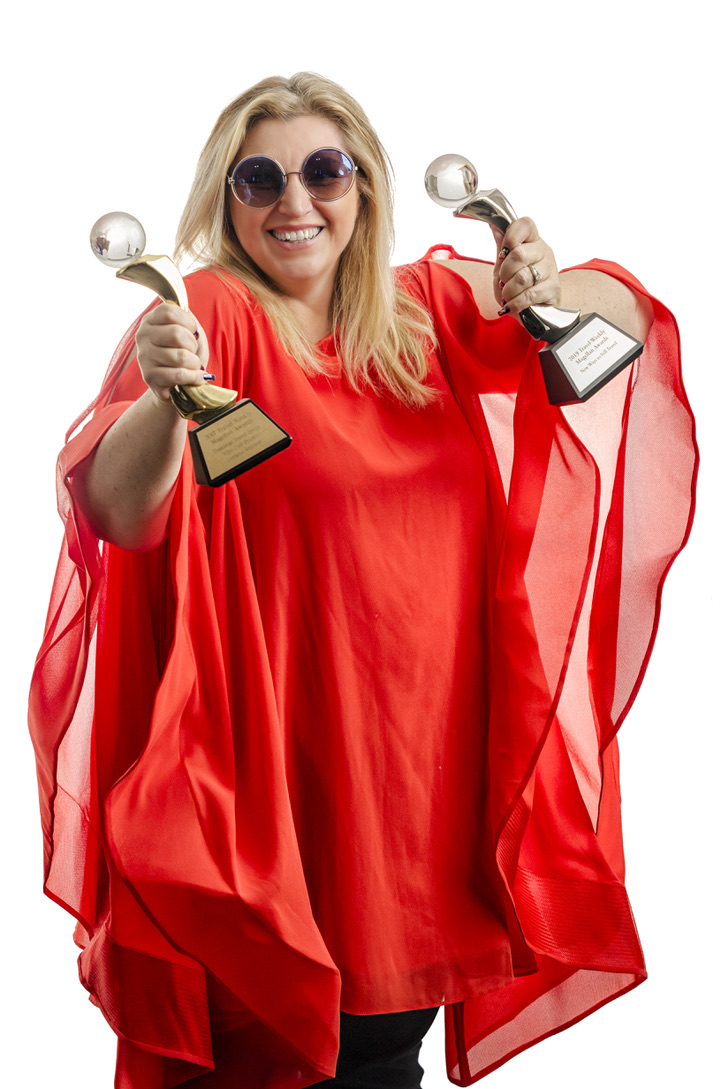 Lorraine holding her Magellan Awards